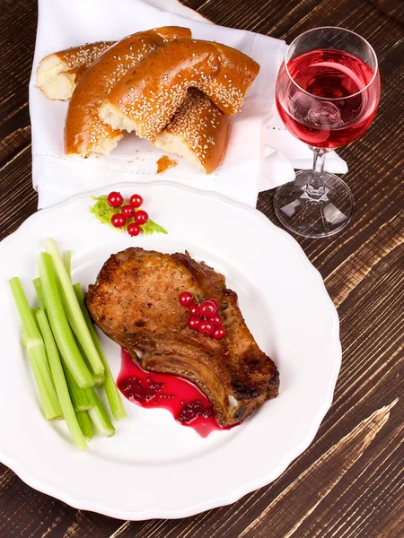 Fried pork chop with red currant sauce and celery — Stock Photo, Image