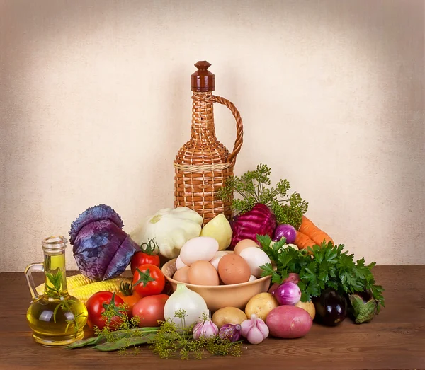 Still life with vegetables, herbs, eggs, oil and bottle of wine — Stock Photo, Image