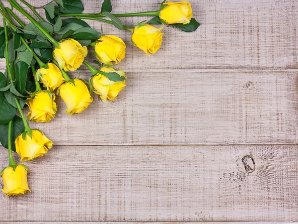 Yellow roses on blue wooden background with space for text — Stock Photo, Image