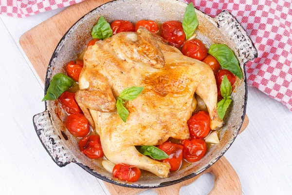 Roast chicken with tomatoes cherry, green basil and garlic