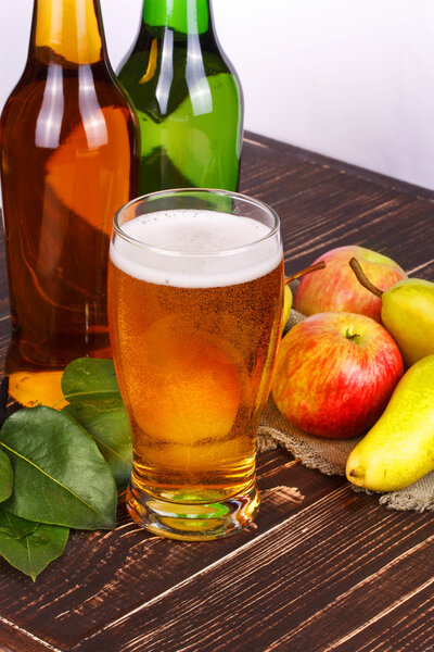 Apple and pear cider glass and bottles with fruits