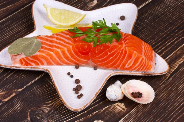Fresh salmon over wooden background — Stock Photo, Image