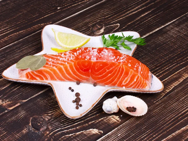 Fresh salmon over wooden background — Stock Photo, Image