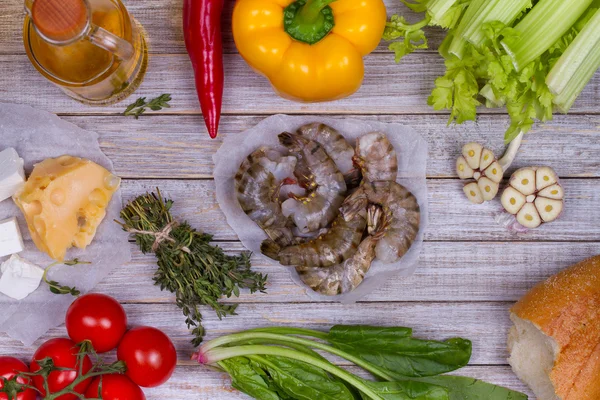 Delicious fresh shrimps and vegetables on wooden background — Stock Photo, Image