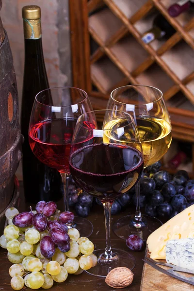 Червоні, рожеві та білі келихи та пляшки вина — стокове фото