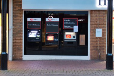 İngiltere 'nin kuzeybatısındaki HSBC bankasının bir şubesinin önünde aydınlatılmış ekranlı üç otomatik para makinesi (ATM)..