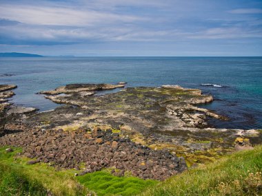 The Guildhall in Derry / Londonderry with the Peace Bridge in the right background. Taken on a sunny day with blue sky and white clouds.