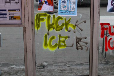 Minneapolis, MN, USA February 7 2026: Graffiti saying fuck ice spray painted inside a bus stop shelter in Minneapolis near Alex Pretti Memorial