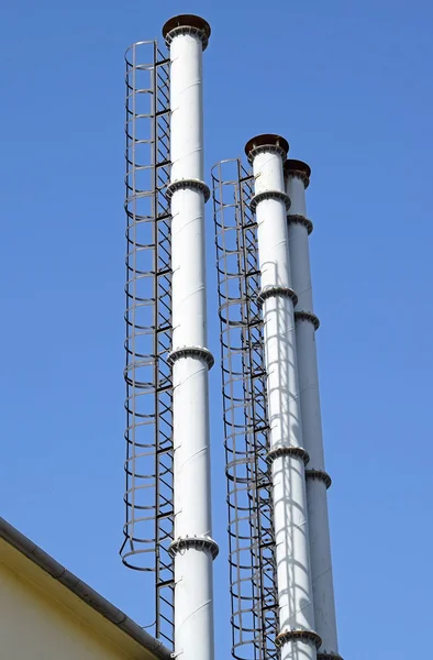 High metal smoke stacks — Stock Photo, Image