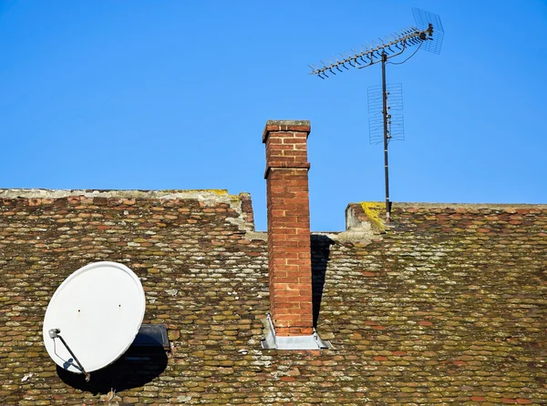 Smoke stack and antennas on the roof — Stock Photo, Image