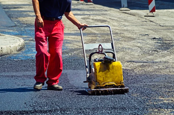 Man is working at the road construction — Stock Photo, Image