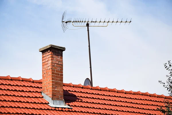 Pilha de fumaça e antena no telhado de um edifício — Fotografia de Stock