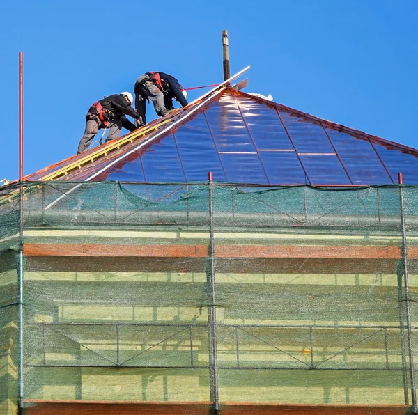 Roofers estão trabalhando no topo de um edifício antigo — Fotografia de Stock