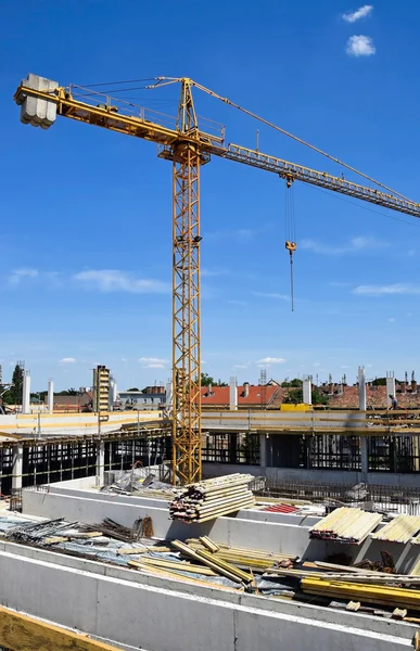 Tower crane is working at the construction site — Stock Photo, Image