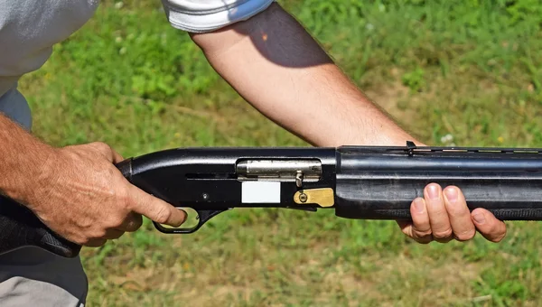 Holding a gun — Stock Photo, Image