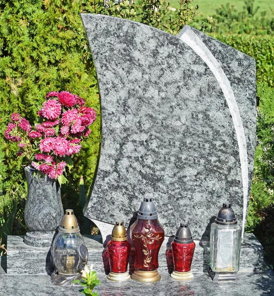 Фонари и цветы на надгробии — стоковое фото