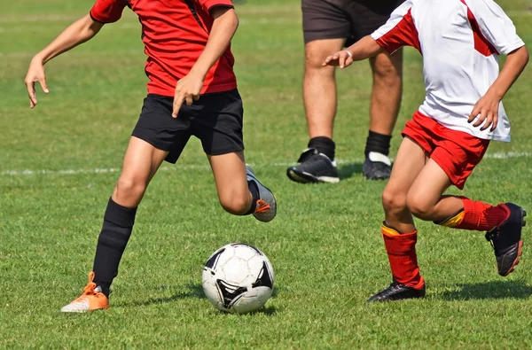 As crianças estão jogando futebol — Fotografia de Stock