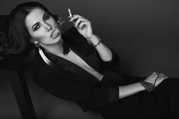 Mulher morena quente elegante fumando um cigarro — Fotografia de Stock