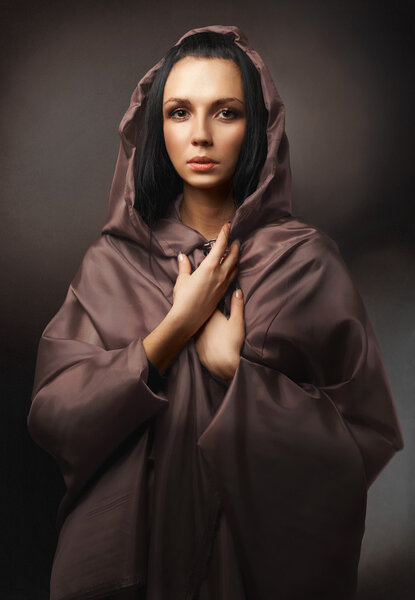 Beautiful young woman in brown robe