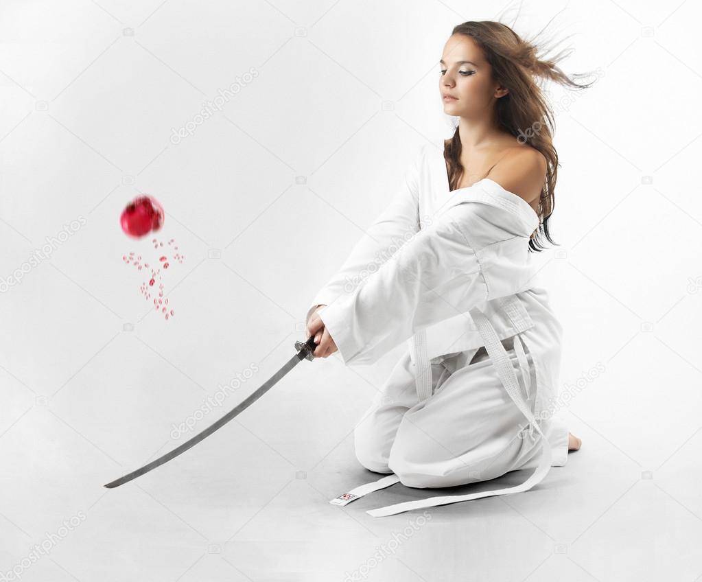 Attractive young sexy women with samurai sword