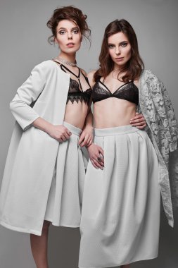 Portrait of two beautiful, sensual brunette models-twins