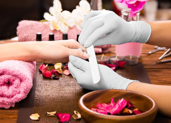 Closeup finger nail care by manicure specialist in beauty salon. — Stock Photo, Image