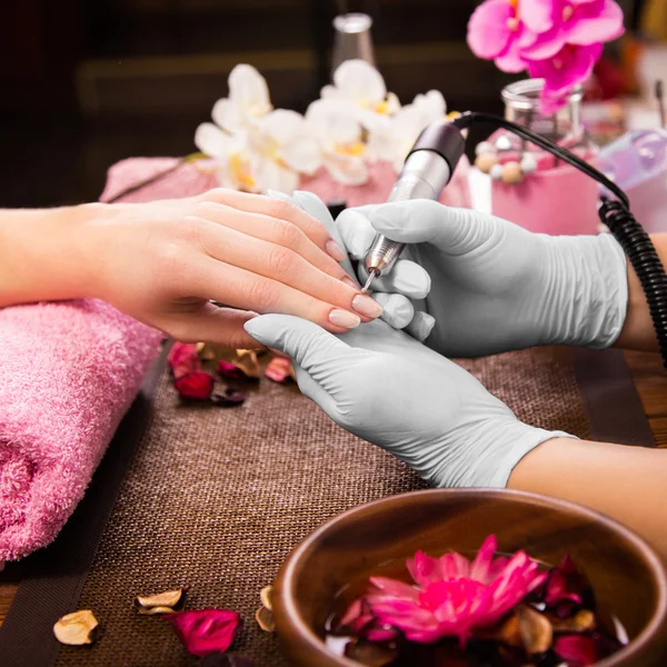 Closeup finger nail care by manicure specialist in beauty salon. — Stock Photo, Image