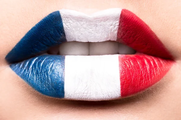 Female lips close up with a picture flag of France. Blue, white, red. — Stock Photo, Image