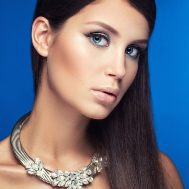 Beautiful woman with evening make-up and long straight hair . Sm