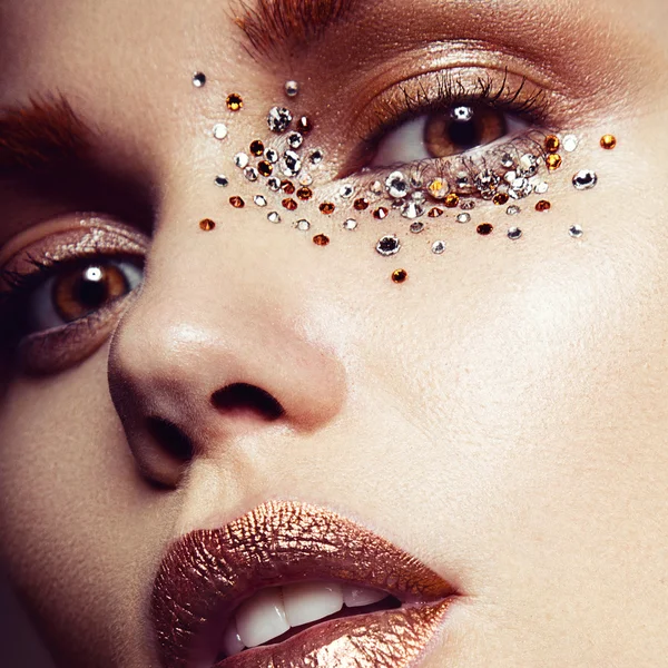 Beautiful girl with a gentle make-up and crystals on the face. — Stock Photo, Image