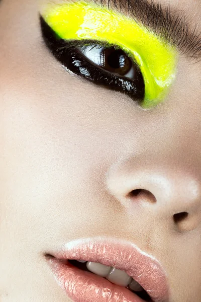 Close-up portrait of girl with yellow and black make-up creative art. Beauty face. — Stock Photo, Image