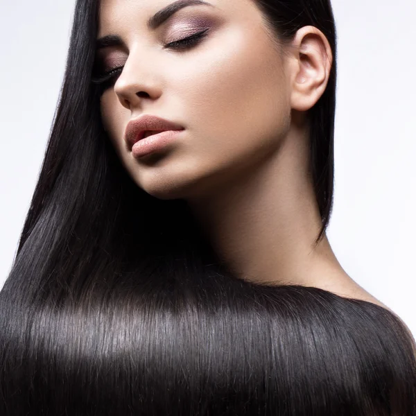 Bella ragazza bruna in movimento con capelli perfettamente lisci e trucco classico. Bellezza viso . — Foto Stock