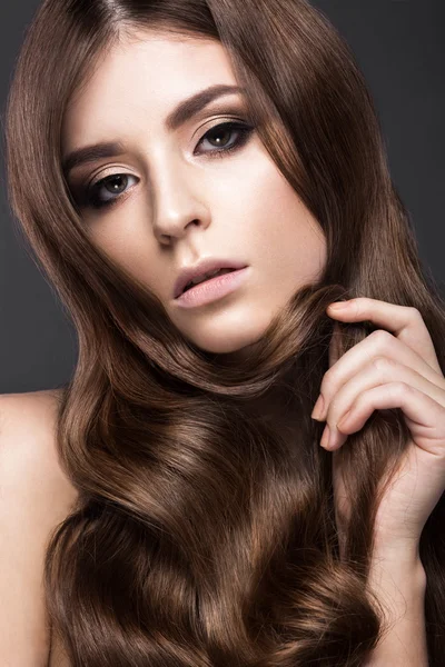 Beautiful brunette girl with a perfectly curls hair and classic make-up. Beauty face. — Stock Photo, Image