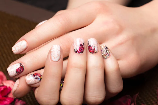 Schöne Maniküre mit Blumen an weiblichen Fingern. Nageldesign. Nahaufnahme — Stockfoto