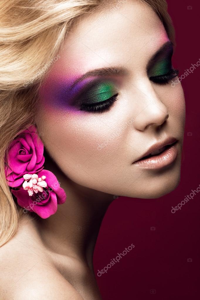 Monument solidariteit Dan Beautiful young blonde woman with creative make-up color and flowers on the  ears. Beauty face. Art makeup. Stock Photo by ©kobrin-photo 113478774