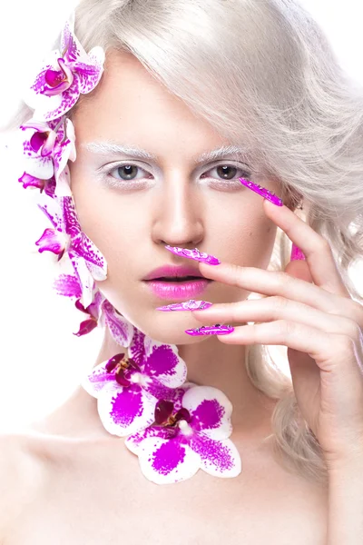 Beautiful girl with art make-up, flowers, curls and long nails. Manicure design. The beauty of the face.