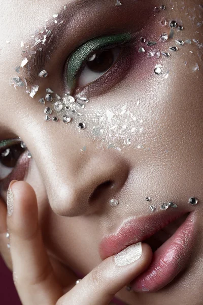 Menina bonita com maquiagem de cor brilhante e cristais no rosto. Retrato de close-up . — Fotografia de Stock