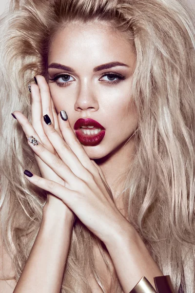 Beautiful sexy blonde girl with sensual lips, fashion hair, black art nails. Beauty face. Stock Picture