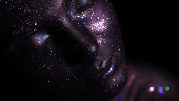 Beautyful girl with black space glitter on her face. Art image beauty face. — Stock Video
