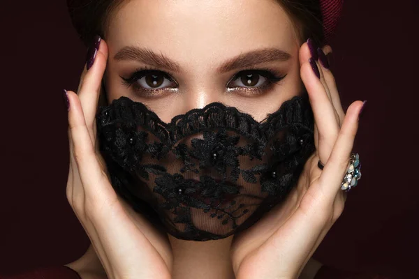 Πορτρέτο μιας όμορφης γυναίκας με μαύρη δαντελένια μάσκα και κλασικό μακιγιάζ. Λειτουργία μάσκας κατά τη διάρκεια της πανδημίας — Φωτογραφία Αρχείου