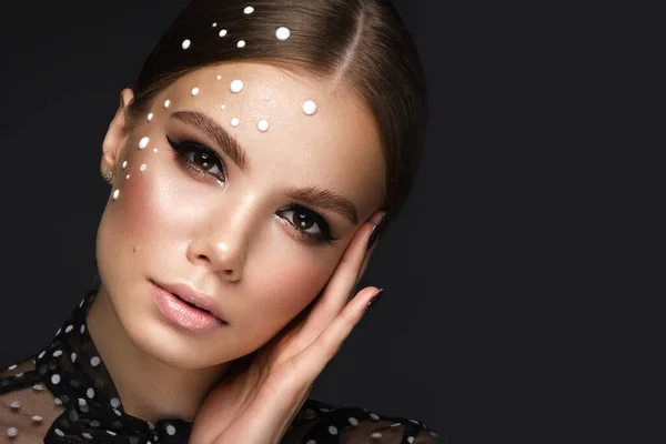 Retrato de una hermosa mujer en un vestido negro con perlas y maquillaje clásico. — Foto de Stock