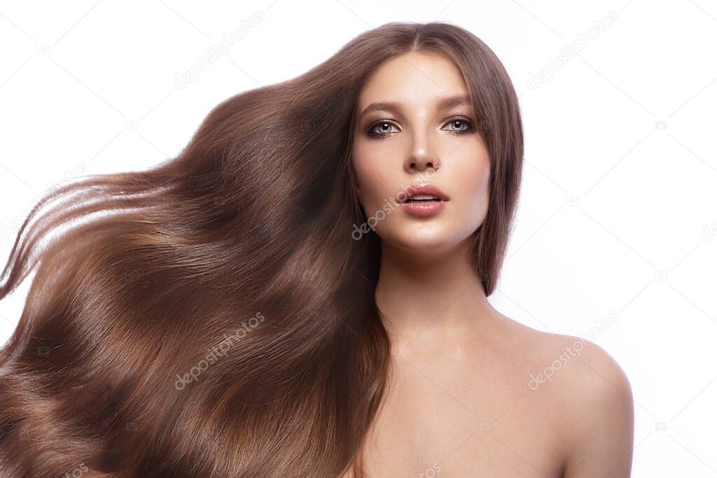 Portrait of beautiful brown-haired woman with a perfectly curls hair, and classic make-up.