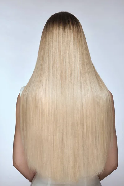 Close-up of shiny smooth blond hair, back view