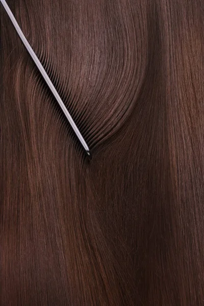 A closeup view of a bunch of shiny straight brown hair — Stock Photo, Image