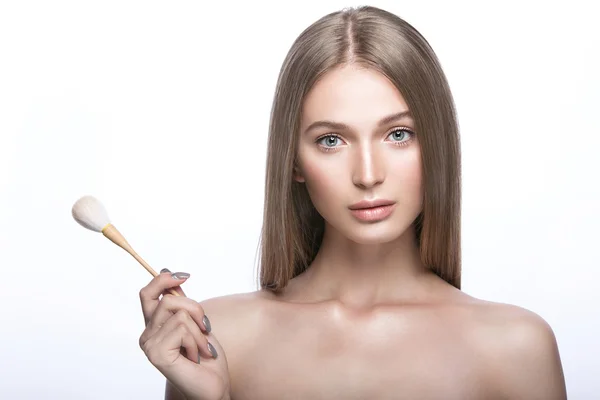 Beautiful young girl with a light natural make-up and beauty tools in hand. — Stock Photo, Image