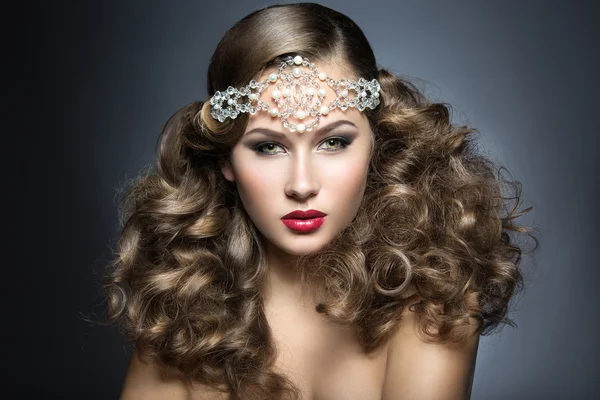 Hermosa mujer con maquillaje de noche y rizos y grandes joyas en la cabeza. Cara de belleza . —  Fotos de Stock