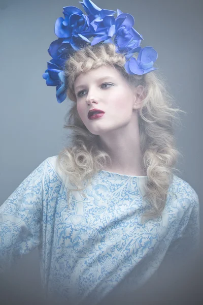 Girl with flowers on her head in a dress in the Russian style. Fog effect. — Stock Photo, Image