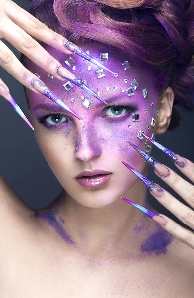 Girl with bright purple creative makeup with crystals and long nails. Beauty face. — Stock Photo, Image
