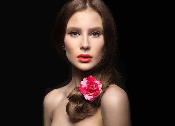 Hermosa chica con labios rojos y una rosa en su pelo. cara de belleza . — Foto de Stock