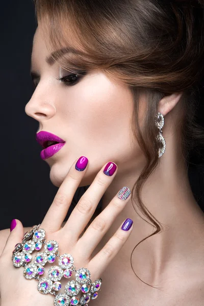 Bir parlak akşam makyaj ve mor manikür ile rhinestones güzel kızla. Tasarım çivi. Güzellik.
